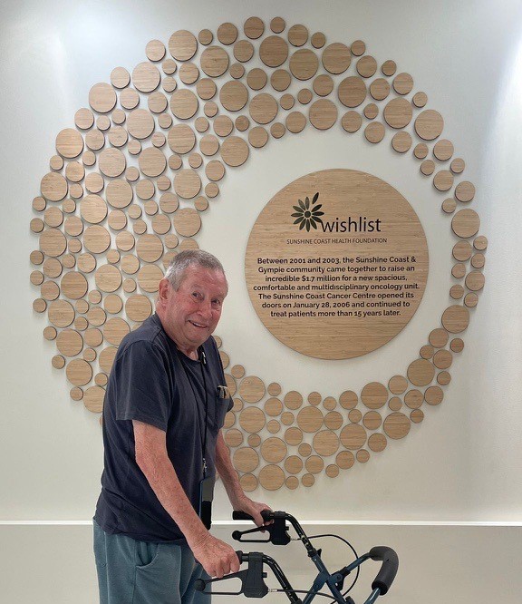 Kim infront of the Nambour Cancer Centre Honour Wall